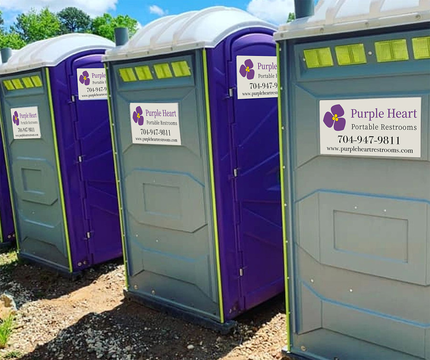 Three Purple Heart Portable Restrooms